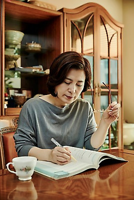포토 JPG 응시 여자 안경 중년 50대 의자 중년라이프 실내 한명 들기 앉기 상반신 앞모습 책 컵 한국인 기록 책상 서랍장 중년여자한명만 국내포토 1 라이프스타일 식기 시선 잡화 뷰포인트 가구 모션 사람 동양인 성인 내부 여자한명만 중년여자만 파일형식
