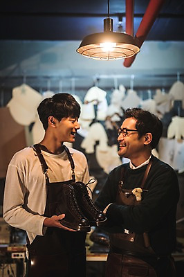 포토 JPG 남자 40대 중년 신발 실내 웃음 사람 상반신 20대 성인 두명 앞모습 마주보기 앞치마 한국인 작업실 고수 제조 가죽 스승 제자 수제화 남자만 가죽공방 국내포토 뷰포인트 모션 표정 동양인 청년 내부 공예 향신료 파일형식