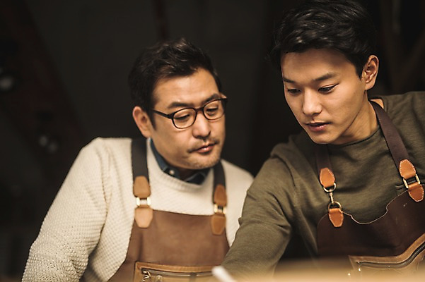 포토 JPG 직업 응시 남자 40대 중년 실내 사람 상반신 20대 성인 두명 앞모습 한국인 작업 가르침 작업실 제조 집중 스승 제자 실습 장인 가죽공예 남자만 안경낌 가죽공방 국내포토 시선 교육 안경 뷰포인트 컨셉 동양인 청년 내부 공예 파일형식