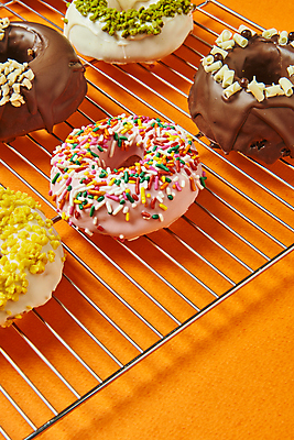 포토 JPG 스튜디오촬영 디저트 실내 종류 사람없음 도넛 달콤 토핑 스프링클 주황색배경 식힘망 국내포토 음식 백그라운드 내부 장식 주방도구 주황색 맛 제빵도구 파일형식