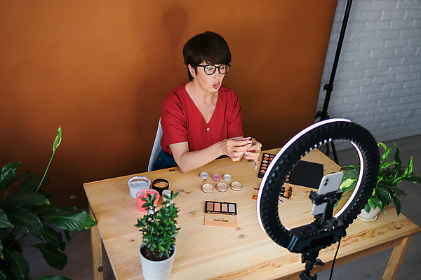 포토 해외이미지 여자 중년 전등 실내 한명 상반신 앞모습 스마트폰 화장 화장용품 방송 화장대 과정 리뷰 소셜네트워크 중년여자한명만 크리에이터 뷰티크리에이터 1인미디어 영상촬영 해외202309 해외포토 직업 1 뷰포인트 가구 컨셉 조명 사람 성인 내부 핸드폰 스마트기기 뷰티 촬영 미용용품 여자한명만 중년여자만 파일형식