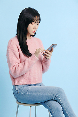 JPG 전신 편집이미지 옷 여자 기술 앉기 스마트폰 청바지 스웨터 집중 파란배경 스마트컨슈머 소통 의료성형뷰티 편집실사 AI인물포토 AI콘텐츠 백그라운드 컨셉 상의 바지 모션 사람 파란색 핸드폰 스마트기기 고객 CG 파일형식 AI포토 컬러 하의 전자제품