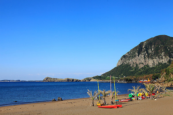 포토 JPG 주간 나무 식물 구름 바다 섬 자연 하늘 산 한국 풍경 해변 사람없음 야외 모래사장 야자수 제주도 맑음 돌_바위 바위 보트 산방산 선박 국내포토 자연요소 아시아 수상교통 배_교통 날씨 생태계 파일형식