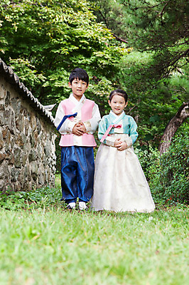 포토 JPG 주간 전신 나무 식물 여자 명절 남자 어린이 돌담 서기 웃음 사람 동양인 소녀 소년 초원 야외 두명 앞모습 유치원생 한국인 한복 손모으기 어린이만 국내포토 자연요소 한국전통 전통 기념일 뷰포인트 모션 표정 인종 손짓 담장 돌_바위 전통의상 파일형식